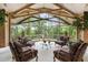 Bright sunroom with wooden beams, large windows overlooking lush greenery, and comfortable seating at 812 Kenmore Rd, Chapel Hill, NC 27514