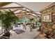 Spacious living room with exposed beams, stone fireplace, large windows, and elegant furnishings at 812 Kenmore Rd, Chapel Hill, NC 27514