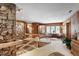 Inviting living room with stone wall, wooden accents, and an open staircase at 812 Kenmore Rd, Chapel Hill, NC 27514