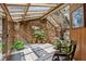 Sunroom featuring wood paneling, skylights, stone accent walls, tiled floor, and a view of the outside at 812 Kenmore Rd, Chapel Hill, NC 27514
