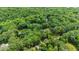 A luxury estate is secluded amidst a dense canopy of trees, as seen from an aerial perspective at 820 Kenmore Rd, Chapel Hill, NC 27514