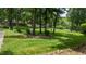 Well-manicured lawn with stone accents and lush greenery creates a serene backyard setting at 820 Kenmore Rd, Chapel Hill, NC 27514