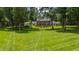 Expansive backyard featuring lush lawn and mature trees creating a serene and private outdoor space at 820 Kenmore Rd, Chapel Hill, NC 27514