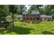 Expansive backyard with mature trees, lush lawn, and a charming sunroom at 820 Kenmore Rd, Chapel Hill, NC 27514