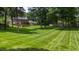 Large, verdant backyard with meticulously maintained lawn and mature trees, perfect for outdoor activities at 820 Kenmore Rd, Chapel Hill, NC 27514