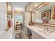 Elegant bathroom featuring a vanity with counter space, a large mirror, and a decorative window for natural light at 820 Kenmore Rd, Chapel Hill, NC 27514