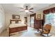 Comfortable bedroom with a wood-frame bed, side tables, dresser, and a rocking chair beneath a window at 820 Kenmore Rd, Chapel Hill, NC 27514