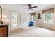 Bright bedroom featuring a ceiling fan, a comfortable chair by the window, and an adjoining bathroom at 820 Kenmore Rd, Chapel Hill, NC 27514