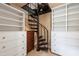 Walk-in closet featuring a spiral staircase and custom shelving at 820 Kenmore Rd, Chapel Hill, NC 27514