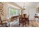 Bright dining room featuring a bay window, chandelier, and traditional wood furniture on an eye-catching patterned rug at 820 Kenmore Rd, Chapel Hill, NC 27514