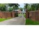 Private estate entrance with brick columns, wrought iron gate and mature trees lining paver driveway at 820 Kenmore Rd, Chapel Hill, NC 27514