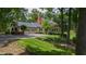 Charming home exterior with a manicured lawn, attached garage, and a delightful screened-in porch at 820 Kenmore Rd, Chapel Hill, NC 27514