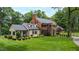 A sprawling brick estate with a manicured lawn surrounded by lush landscaping at 820 Kenmore Rd, Chapel Hill, NC 27514
