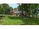 Sprawling estate with brick and siding, expansive lawn and mature trees creating a private oasis at 820 Kenmore Rd, Chapel Hill, NC 27514