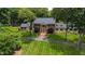 Stately home boasts manicured lawn, mature trees, classic architecture and center columned front entry at 820 Kenmore Rd, Chapel Hill, NC 27514