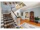 Beautiful foyer with elegant chandelier, staircase, and hardwood floors leading into adjacent rooms at 820 Kenmore Rd, Chapel Hill, NC 27514