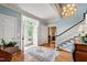 Inviting foyer showcasing hardwood floors, an elegant staircase, and a charming chandelier at 820 Kenmore Rd, Chapel Hill, NC 27514