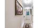 Inviting hallway with neutral walls, tile flooring, and recessed lighting, complemented by a decorative rug and wall art at 820 Kenmore Rd, Chapel Hill, NC 27514