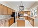 Spacious kitchen with wood cabinets, central island, stainless steel appliances, and elegant countertops at 820 Kenmore Rd, Chapel Hill, NC 27514