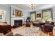 Cozy living room with a fireplace, rich hardwood floors, comfortable seating, and elegant decor creating a warm atmosphere at 820 Kenmore Rd, Chapel Hill, NC 27514