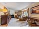 Bright living room with a fireplace, complemented by an adjacent desk area at 820 Kenmore Rd, Chapel Hill, NC 27514