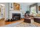 Comfortable living room featuring a fireplace, rich hardwood floors, and comfortable seating, perfect for relaxing by the fire at 820 Kenmore Rd, Chapel Hill, NC 27514