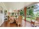 Bright sunroom featuring brick floors, large windows, and comfortable wicker furniture overlooking a lush backyard at 820 Kenmore Rd, Chapel Hill, NC 27514