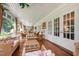 Inviting sunroom with brick floors, ample seating, and large windows offering serene views of the surrounding landscape at 820 Kenmore Rd, Chapel Hill, NC 27514