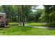 A well-manicured lawn and sculpted shrubbery highlight this home's beautiful yard and landscaping at 820 Kenmore Rd, Chapel Hill, NC 27514