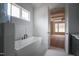 Modern bathroom with a freestanding tub and a view of an adjacent room at 913 Harrison Ridge Rd, Wake Forest, NC 27587