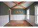 Dining room with hardwood floors, wainscoting, and vaulted ceiling with exposed beams at 913 Harrison Ridge Rd, Wake Forest, NC 27587