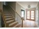 Bright foyer featuring hardwood floors, craftsman trim, and a view of the staircase at 913 Harrison Ridge Rd, Wake Forest, NC 27587