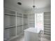 Spacious walk-in closet with custom shelving and an island for added storage at 913 Harrison Ridge Rd, Wake Forest, NC 27587