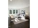 Sunlit living room with large windows, comfortable seating, and stylish decor at 966 Double Helix Rd, Apex, NC 27523