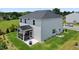 Backyard with a screened-in porch, fire pit and lush green lawn at 10 Forest Brook Way, Clayton, NC 27520