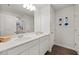 Bathroom showcasing double sinks, wood-look floor, and a framed set of blue flower pictures at 10 Forest Brook Way, Clayton, NC 27520