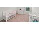 Cozy Bedroom with a white crib, dresser, and changing table; designed with calming neutral tones at 10 Forest Brook Way, Clayton, NC 27520