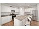A modern kitchen featuring white cabinets, stainless steel appliances, and a center island with seating at 10 Forest Brook Way, Clayton, NC 27520