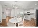 Kitchen featuring an open-concept with white cabinets, granite countertops, and stainless appliances at 10 Forest Brook Way, Clayton, NC 27520