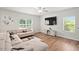 Cozy living room features a large L-shaped couch, tv and media center, and lots of natural light at 10 Forest Brook Way, Clayton, NC 27520