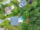 Aerial view showcases the property's lush landscaping, neighborhood and backyard swimming pool at 1003 Burnt Hickory Ct, Apex, NC 27502