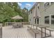 Spacious backyard deck with multiple seating options, umbrellas, and lush greenery views at 1003 Burnt Hickory Ct, Apex, NC 27502