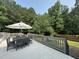 Relaxing outdoor deck features dining area with seating, with the privacy of surrounding trees at 1003 Burnt Hickory Ct, Apex, NC 27502