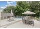 Inviting backyard deck with multiple seating areas, umbrellas, and a glimpse of the refreshing pool at 1003 Burnt Hickory Ct, Apex, NC 27502