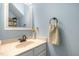 Powder room features a modern vanity and soft blue walls at 1003 Burnt Hickory Ct, Apex, NC 27502