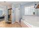 Bright bathroom features a shower and soaking tub at 1003 Burnt Hickory Ct, Apex, NC 27502