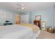 Cozy bedroom featuring a ceiling fan, neutral walls, and a comfortable bed with a white comforter at 1003 Burnt Hickory Ct, Apex, NC 27502