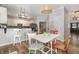 Eat-in kitchen boasts a woven pendant light and white cabinets at 1003 Burnt Hickory Ct, Apex, NC 27502
