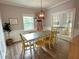Cozy dining room features modern lighting fixture and wood flooring, perfect for Gathering meals at 1003 Burnt Hickory Ct, Apex, NC 27502