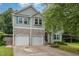 Charming two-story home with a stone and siding exterior, a well-maintained yard, and an attached two-car garage at 1003 Burnt Hickory Ct, Apex, NC 27502